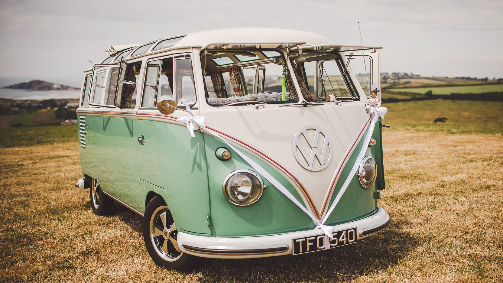 Side view of retro campervan with front and side windows open