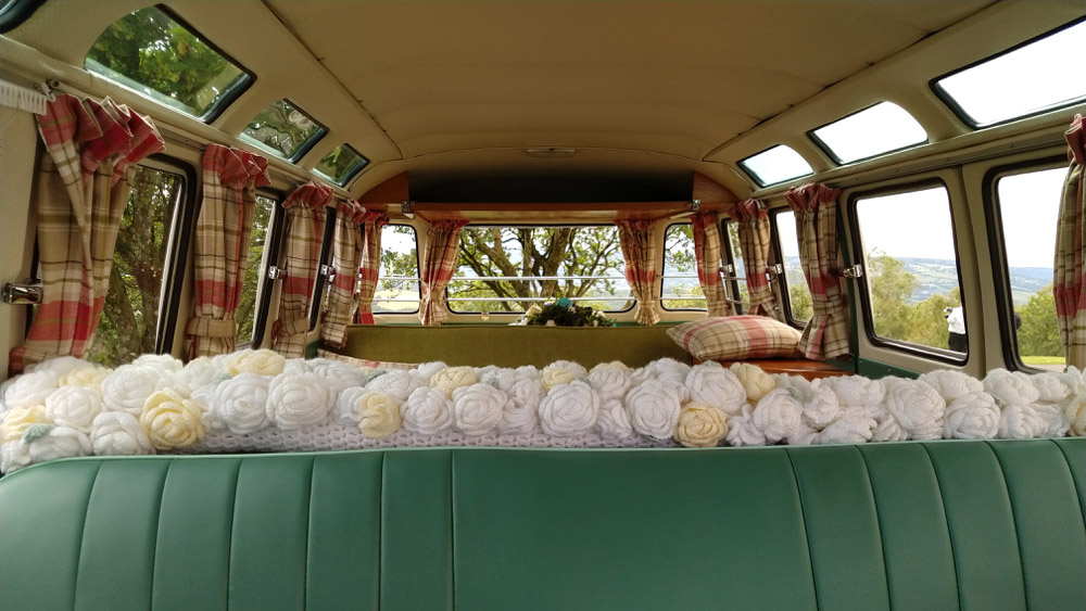 interior photos of campervan with green seats, sunroof closed and curtains on the side windows