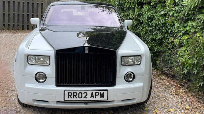 Front view of white Rolls-Royce Phantom with Black Bonnet