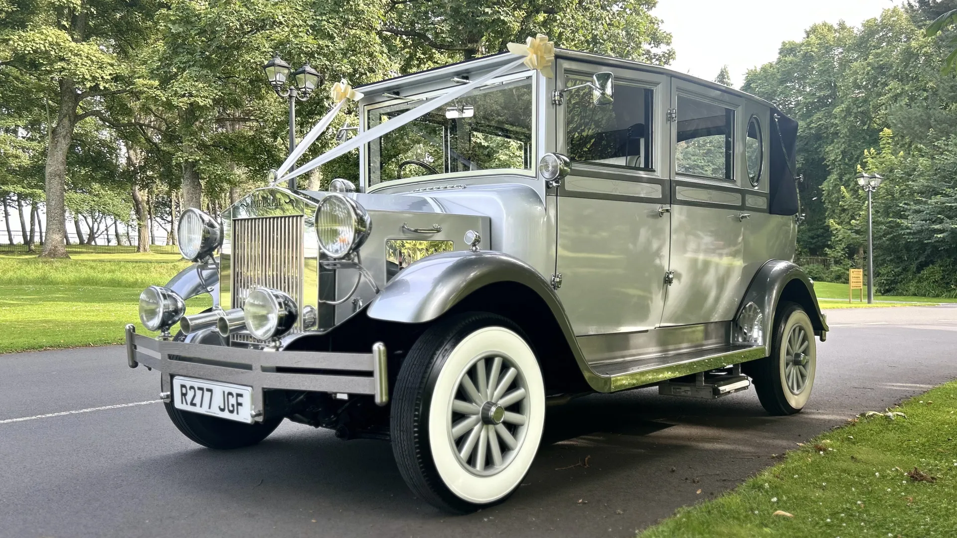 Left side view of silver imperail car dressed with Ivory Ribbons in a local Park in Ayr.