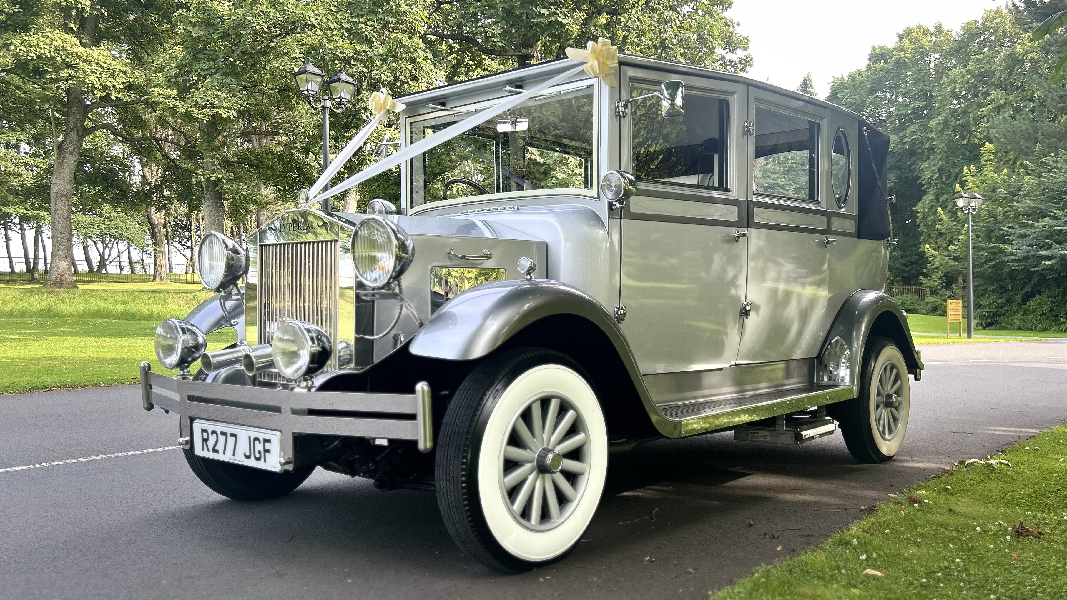 Left side view of silver imperail car dressed with Ivory Ribbons in a local Park in Ayr.