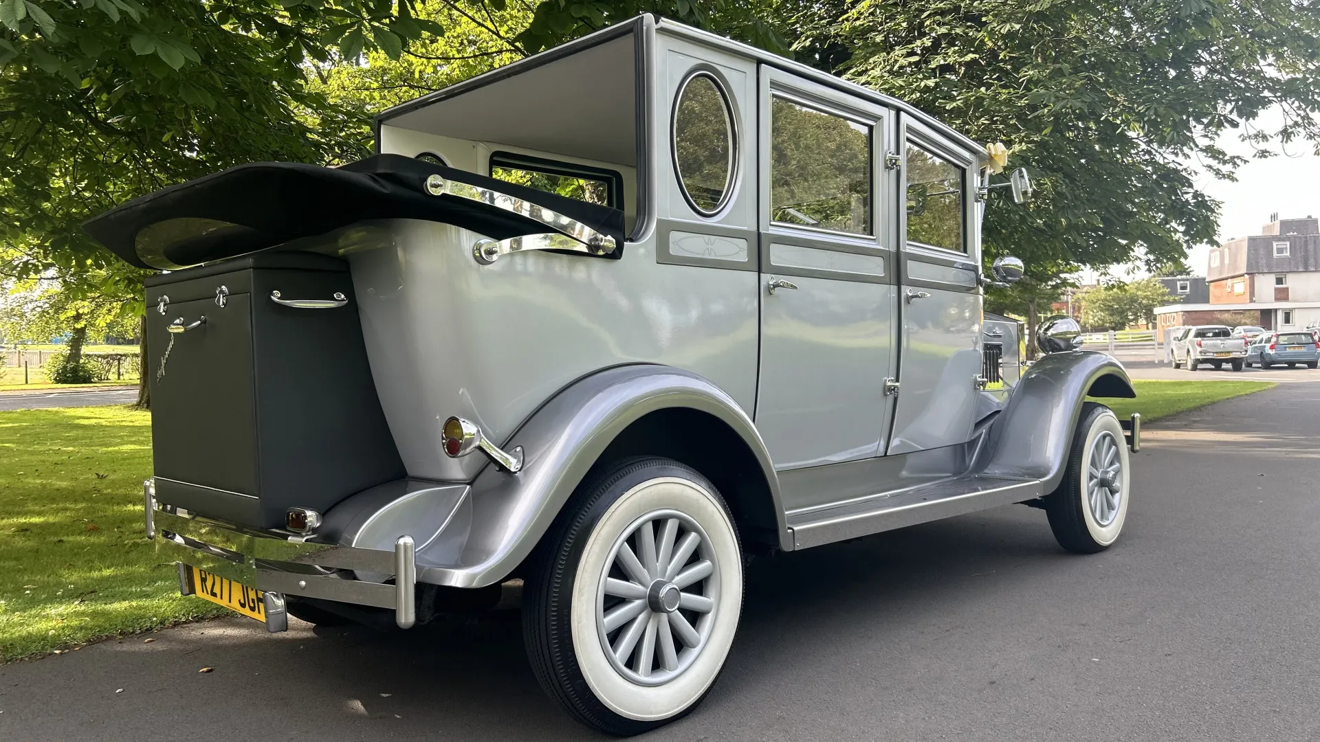 Rear view of Silver Imperial wedding car with roof down