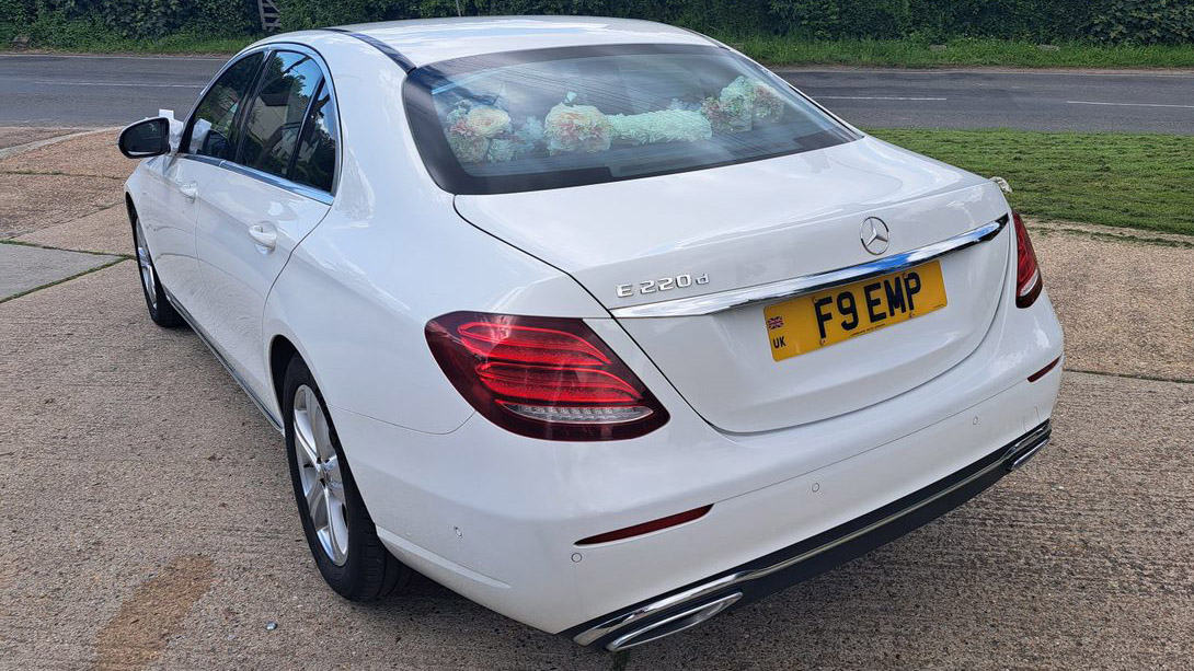 rear view of Mercedes showing flowers on the rear parcel shelf through the window