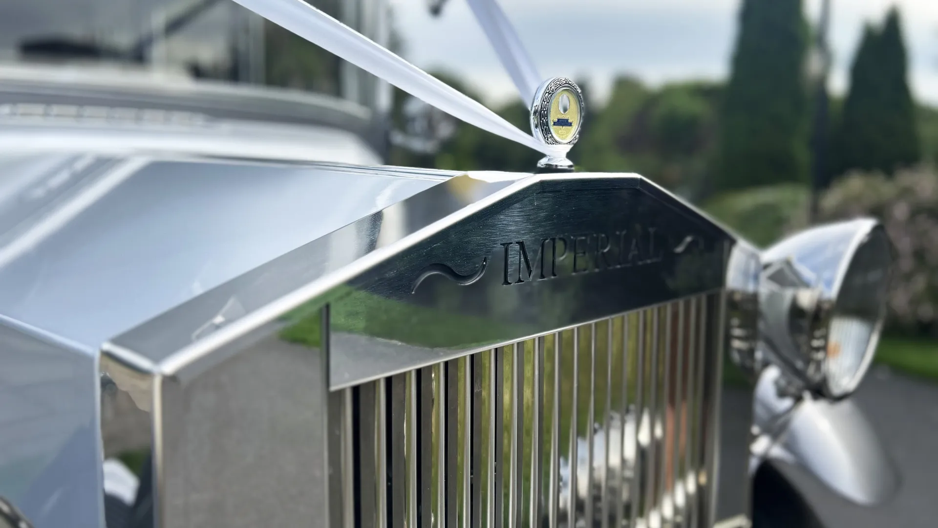 Top chrome Grill with imperial logo and white ribbon attached to the grill