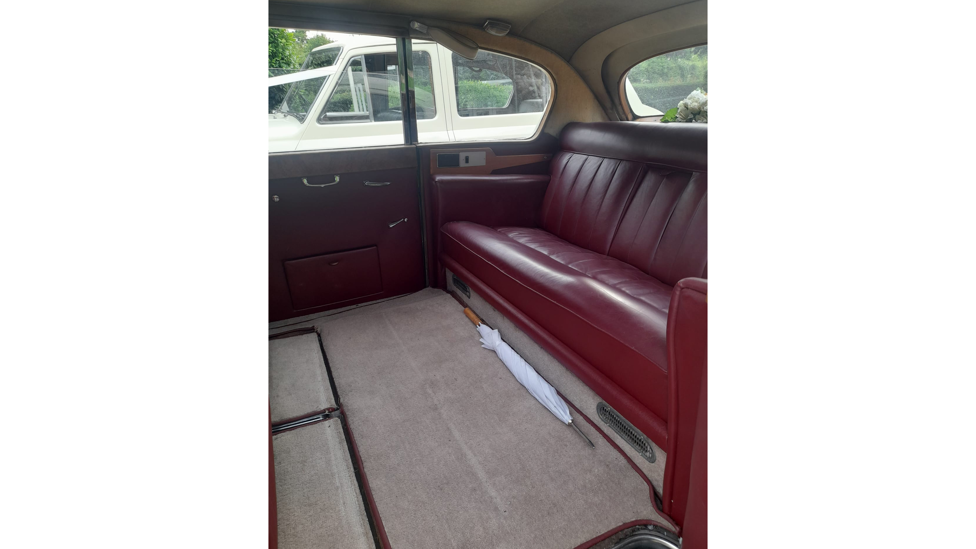 Rear interior cabin inside Austin Princess with Cream carpet and Burgundy Seat