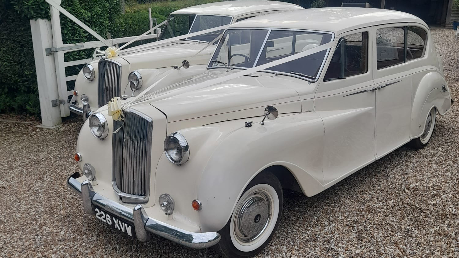 Left side view of a classic 7-seater Austin Princess Limousine in Old English White with White ribbons