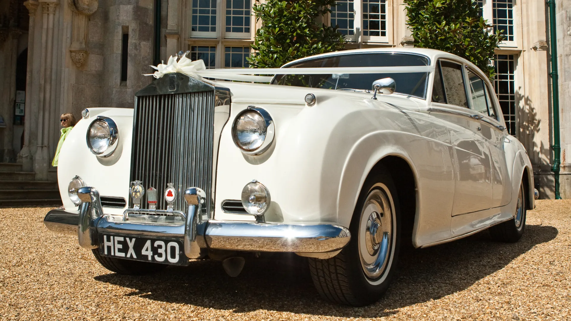 Classic Rolls-Royce Silver Cloud I dressed with Ivory Ribbons in front of Highcliffe Castle in Dorset