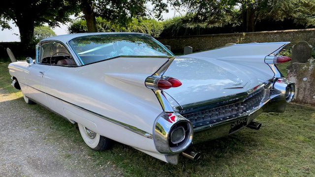 left rear view of white cadillac