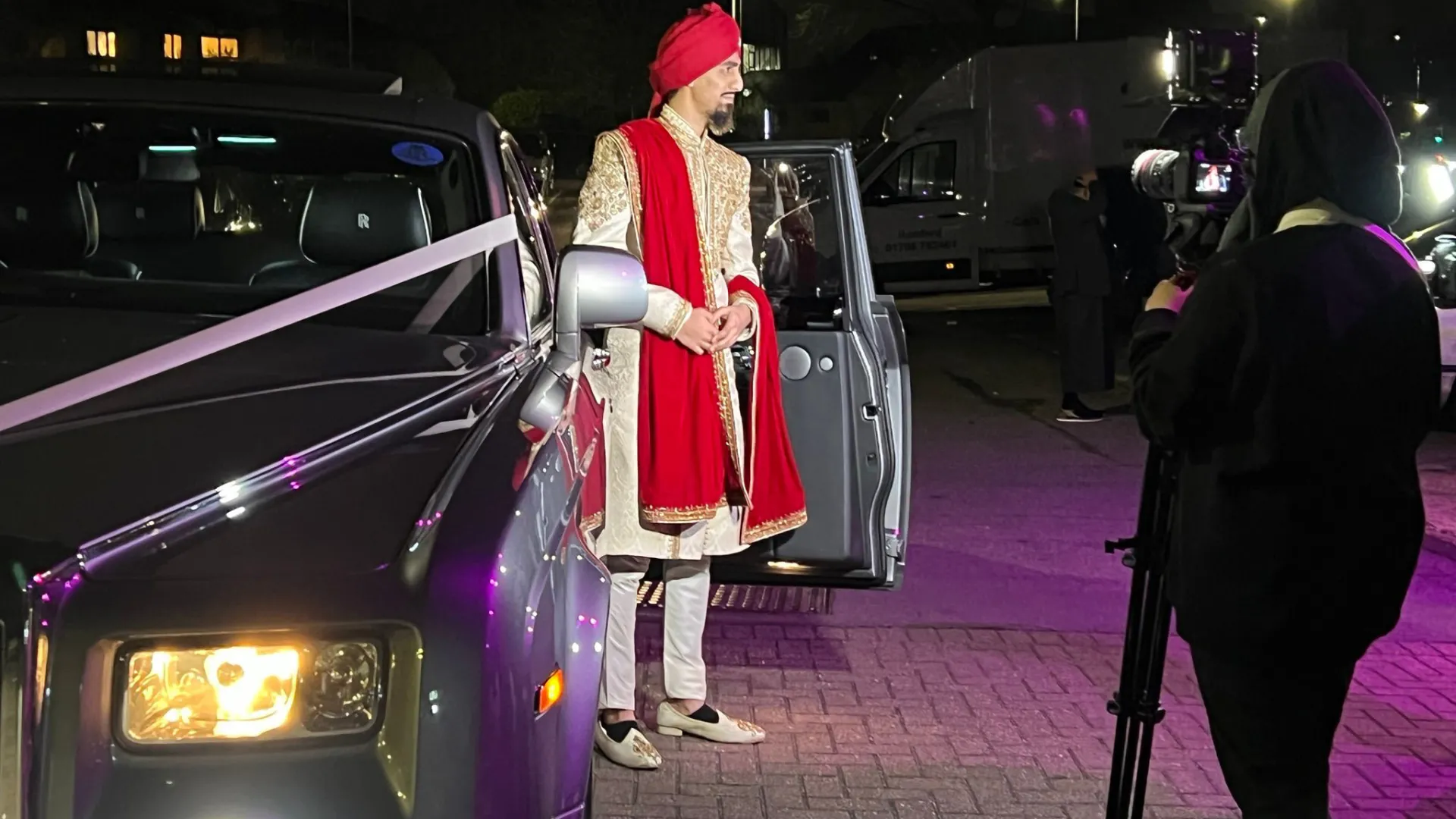 Asian groom stepping out of Silver interior view of Rolls-Royce Phantom.