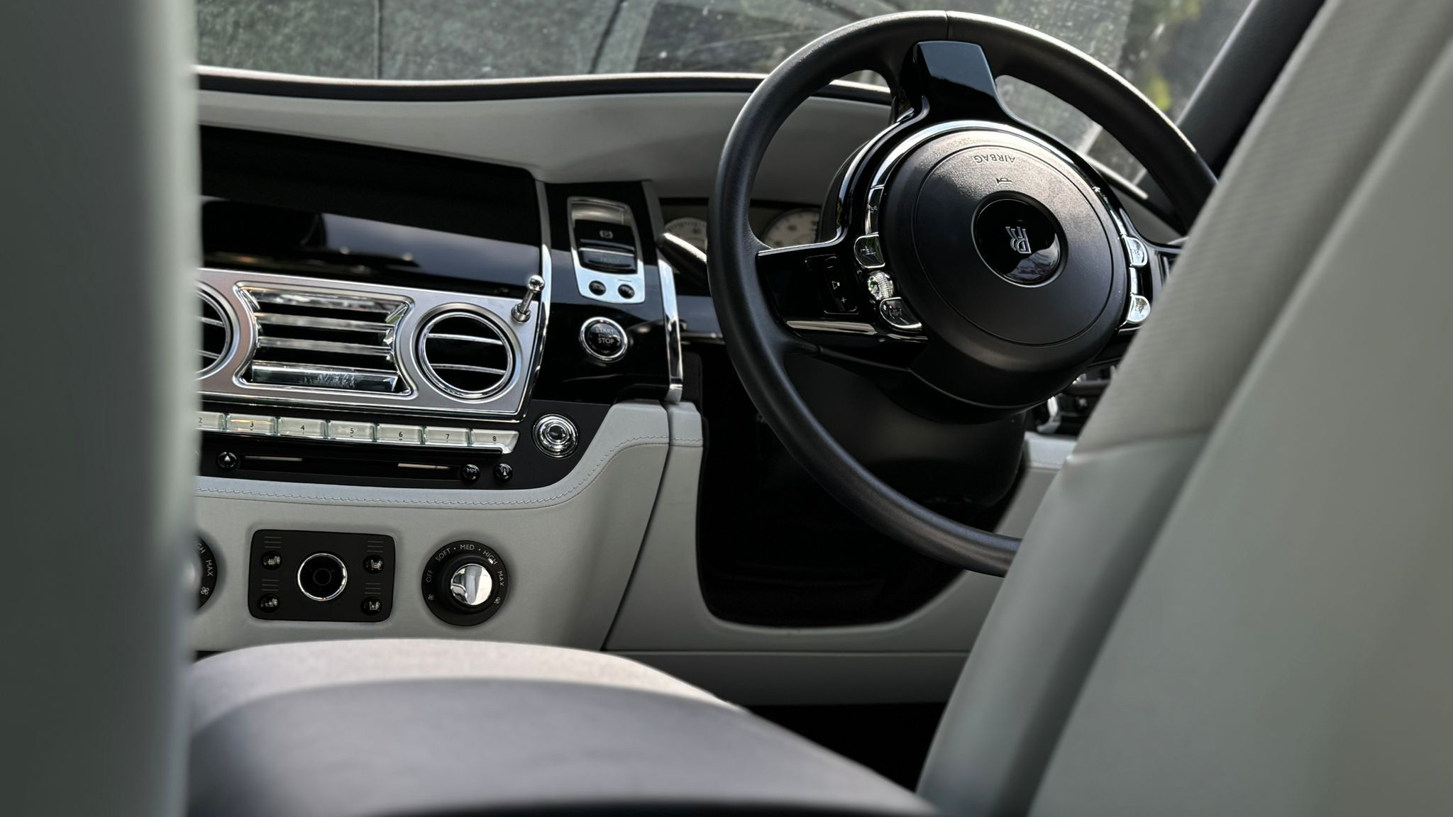 Front view of dashboard and steering wheel inside Rolls-Royce Ghost