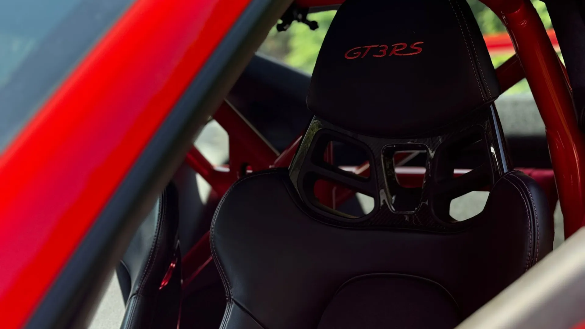 Black interior inside Porsche with GT3 RS red stiches on headrests