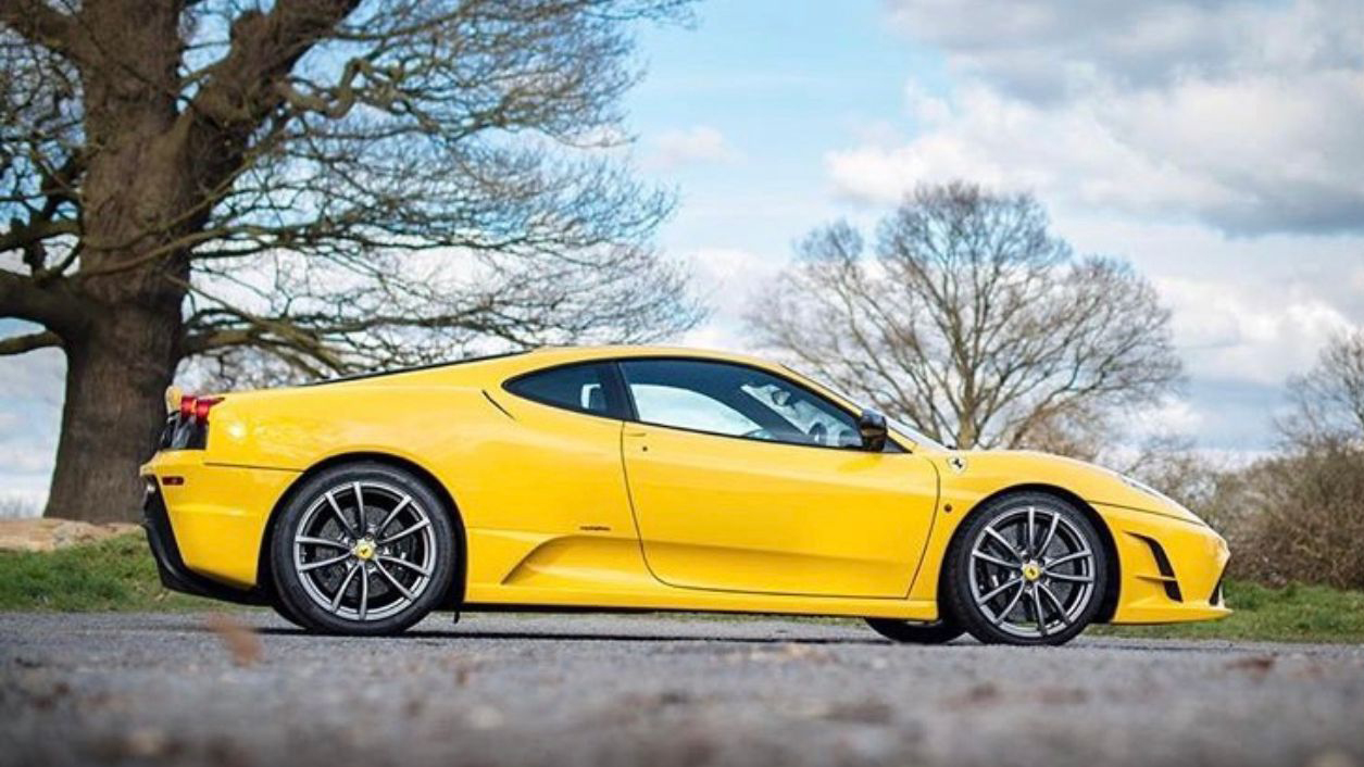 Full right side view of Yellow Ferrari 430 Scuderia with large alloy wheels