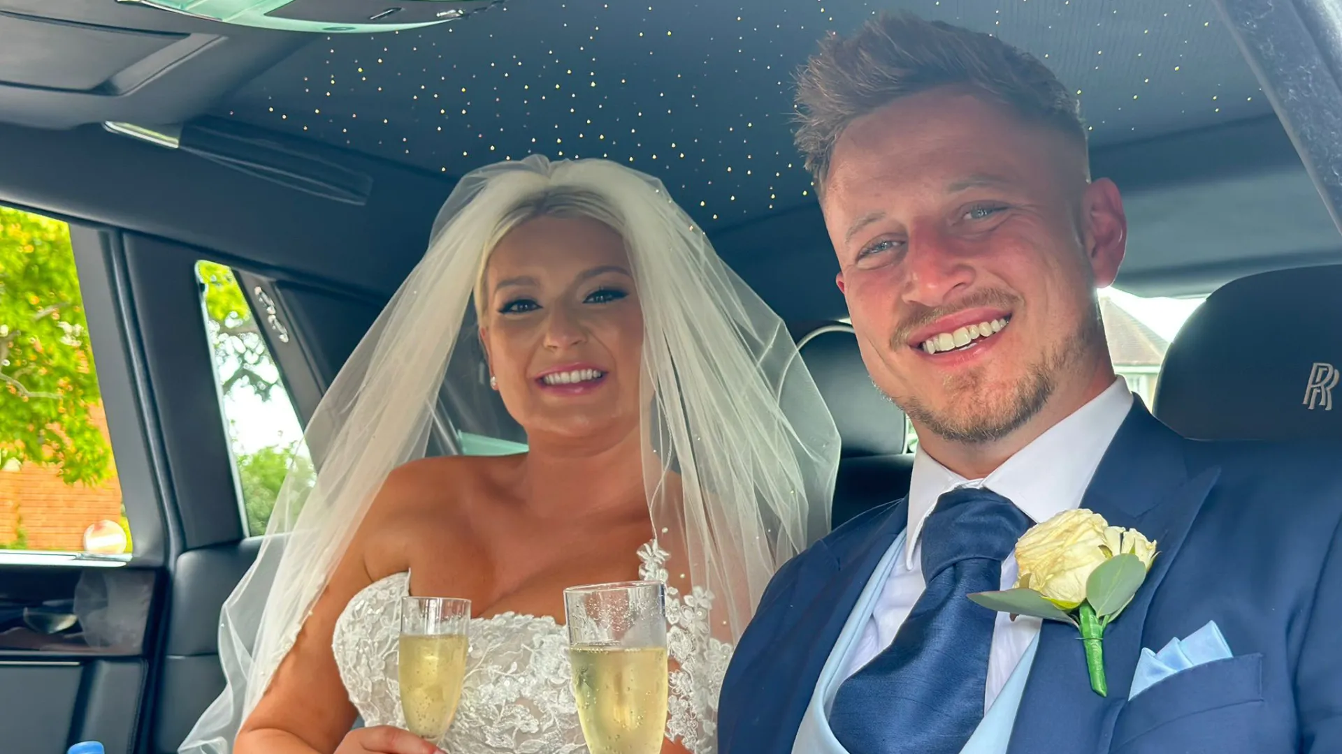 Couple smiling seated inside the Rolls-Royce Phantom