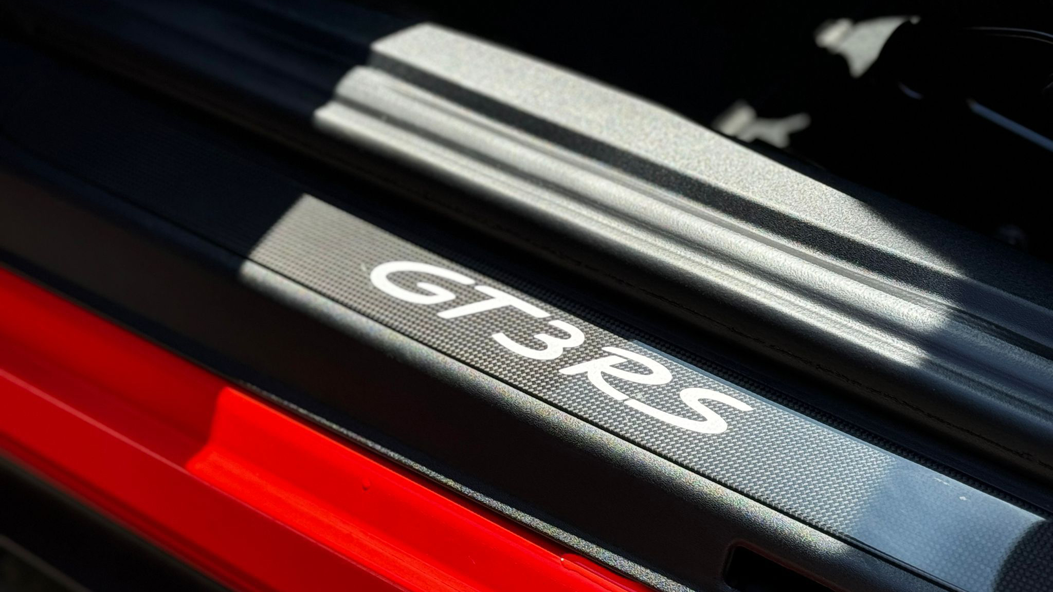 GT3 RS logo on door step of Red Porsche