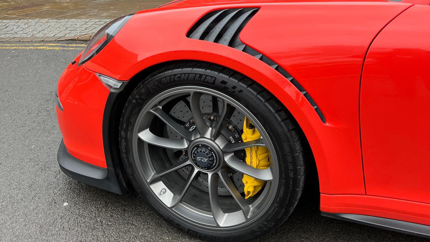 Close up view of alloy wheels on a Red Porsche GT3 RS