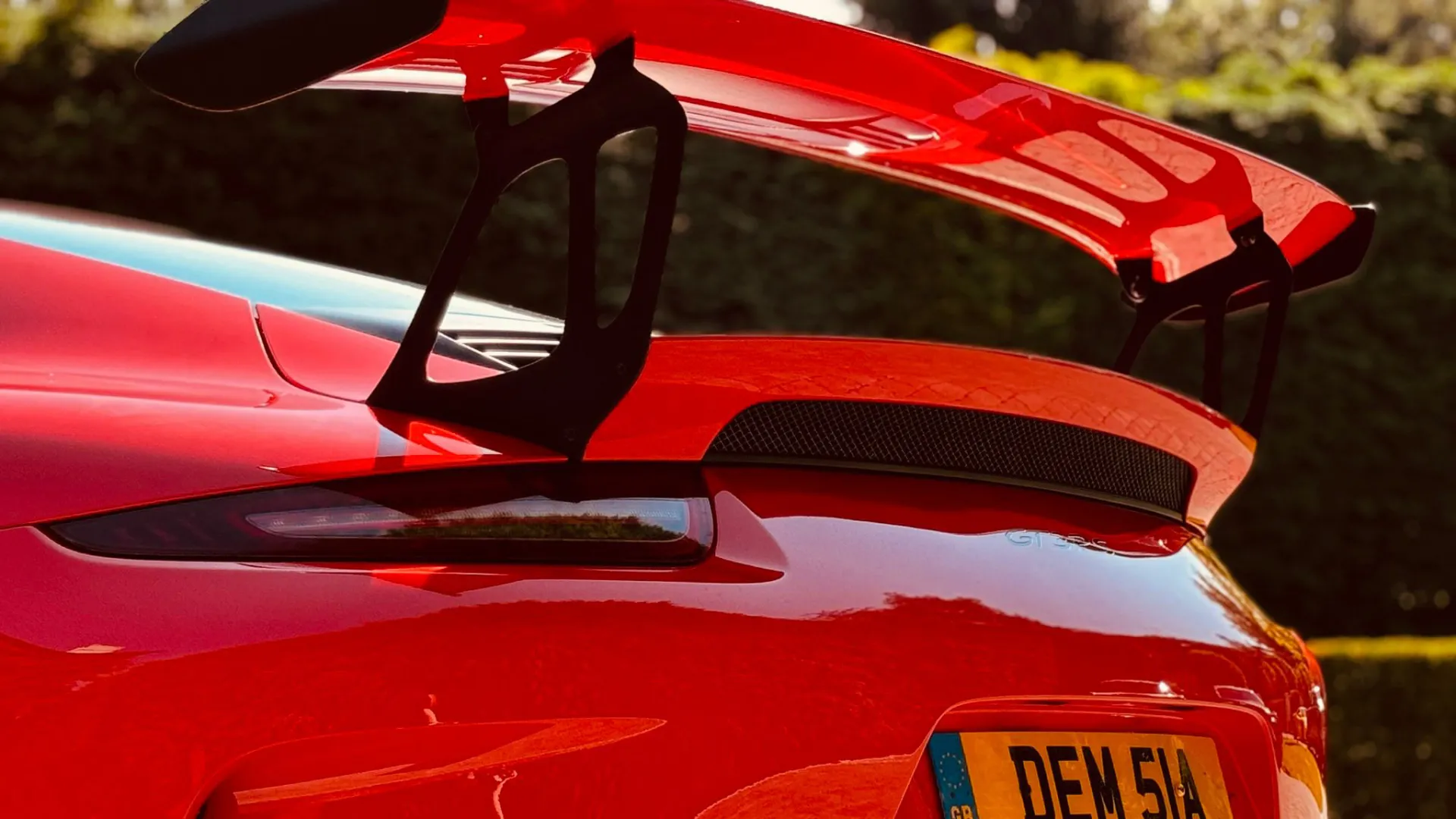 rear spolier view of Red Porsche