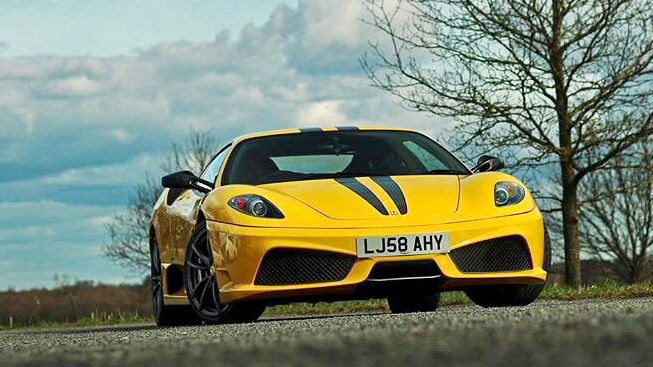 Front view of Yellow Ferrari 430 with two thin black stripes on front bonnet