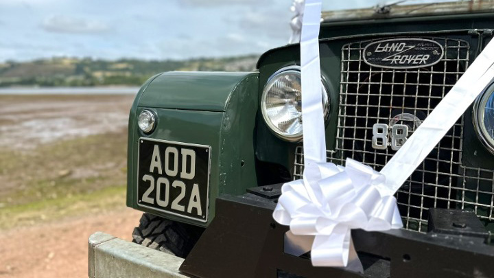 large white bow attached to Landrover bumper.