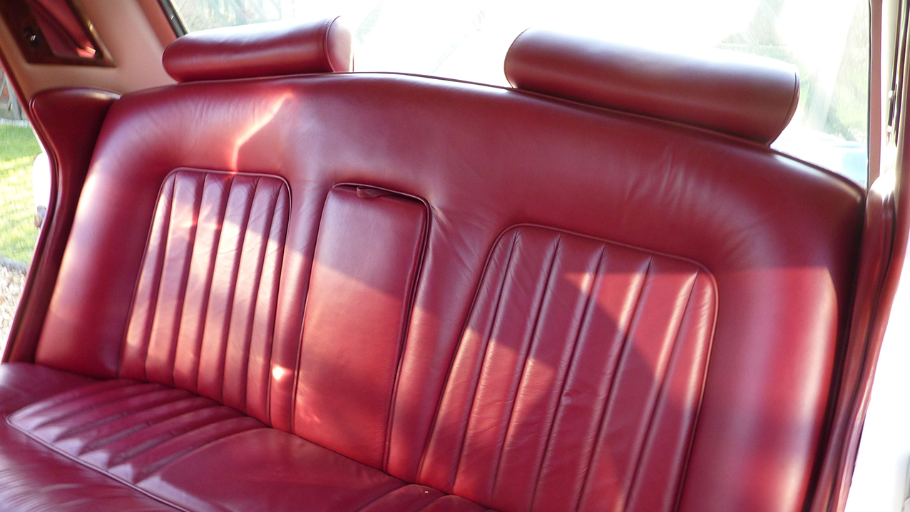 Rear interior Burgundy Leather seat inside a 1974 Classic Rolls-Royce Silver Shadow