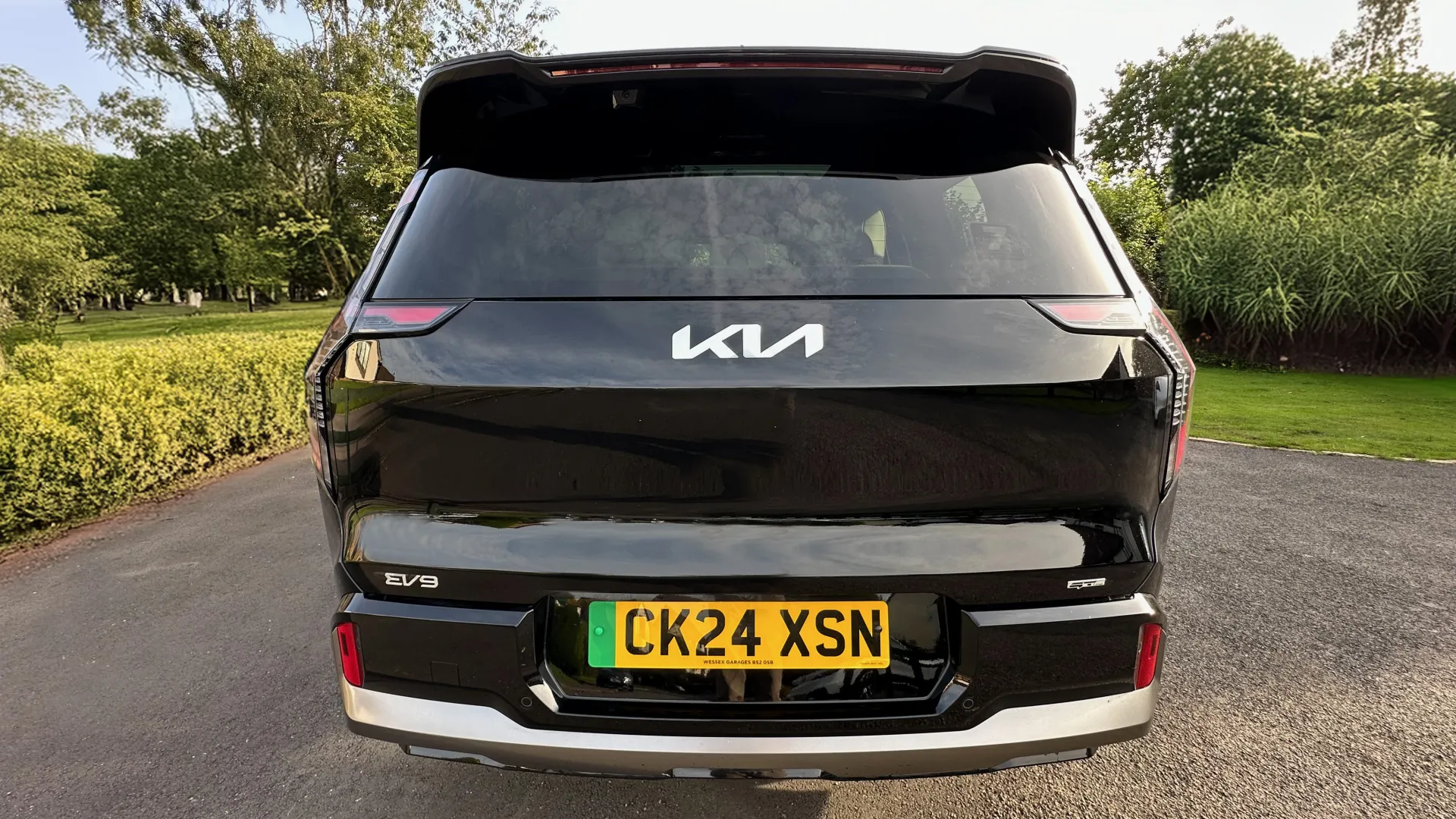 Full rear view of Black KIA SUV