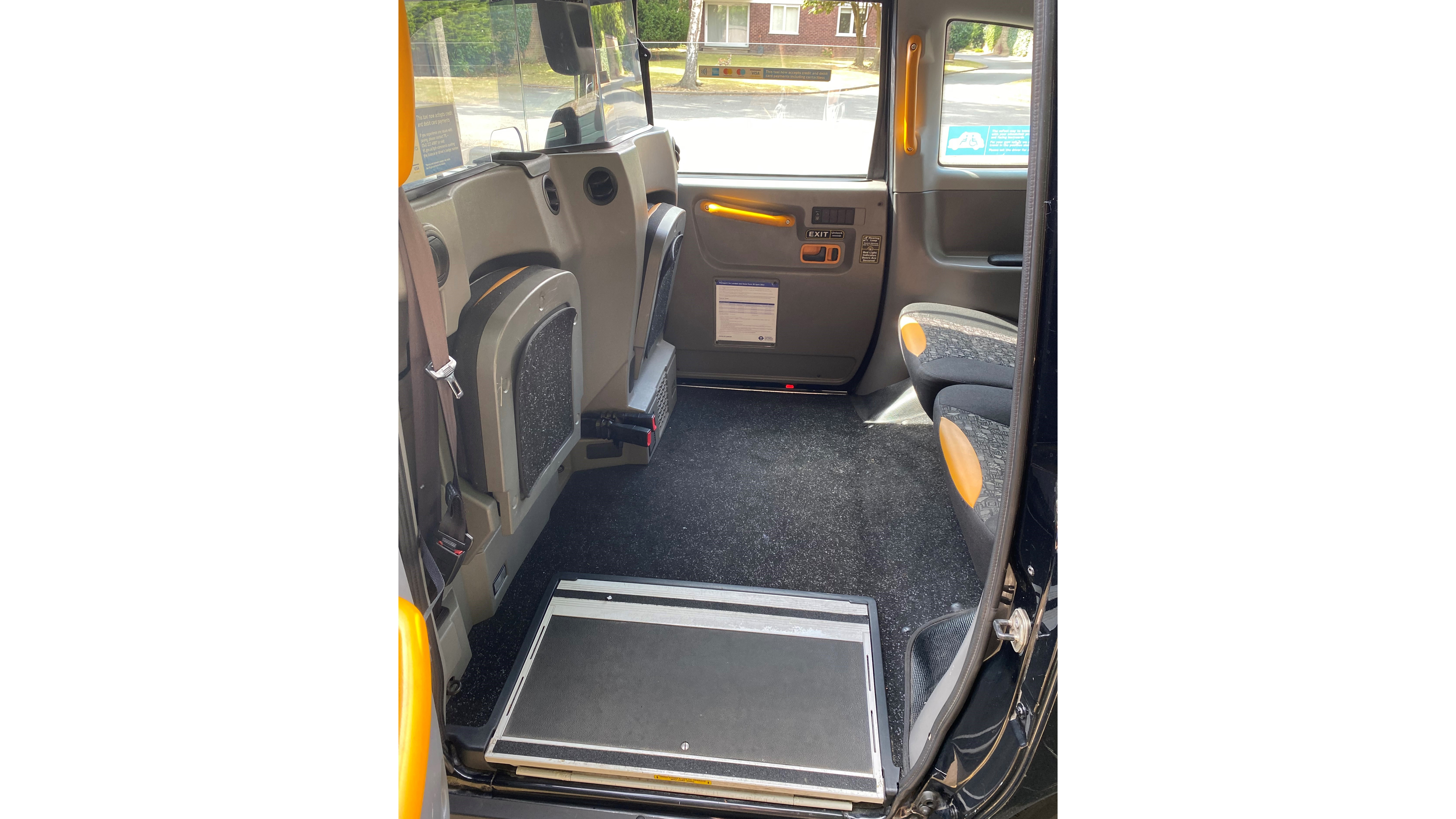 Black London Taxi Cab interior seating area with disable step for easy access