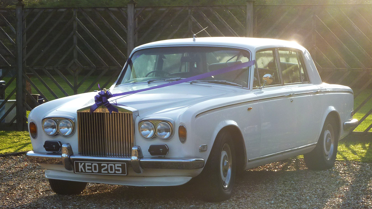 Left front view of 1974 Silver Shadow with purple ribbons and bow