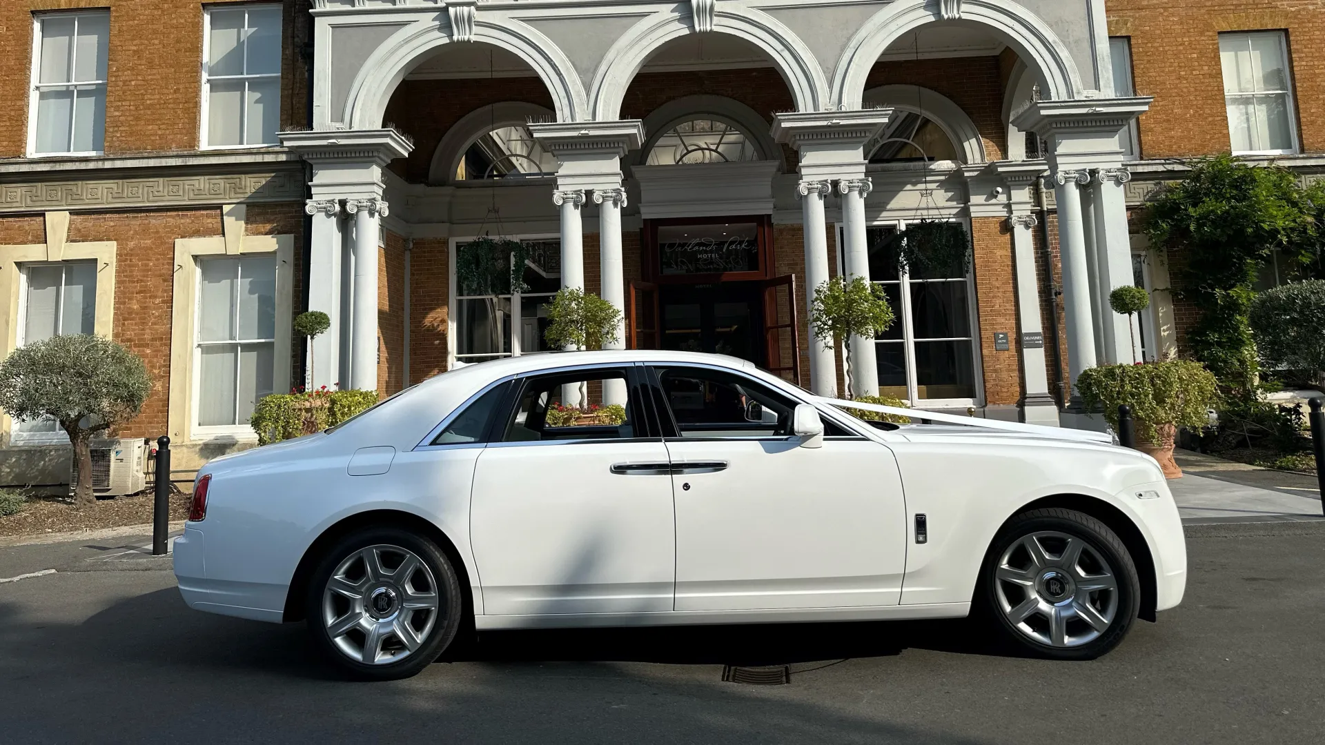 Right side view of white Rolls-Royce Ghost in front of wedding venue in Weybridge