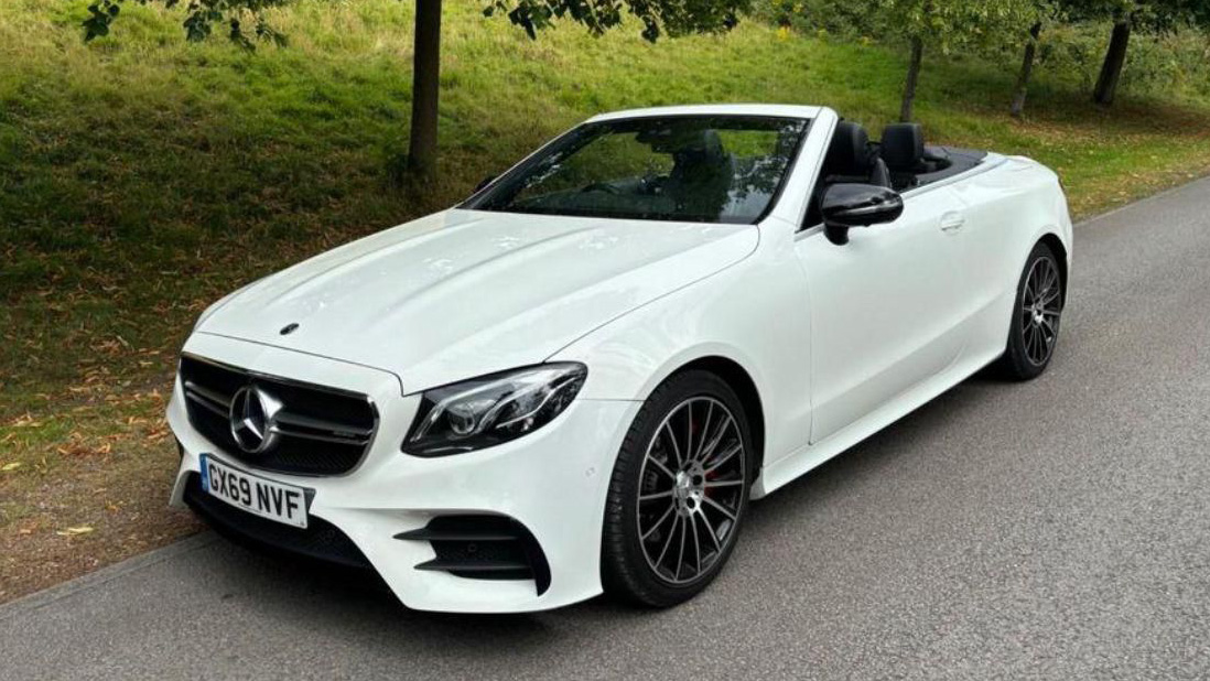 Fropnt side view of Convertible White Mercedes E-Class with roof down