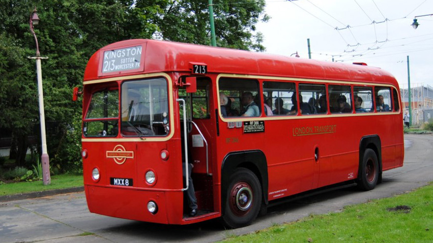 Vintage Red Single Decker Bus with wedding guests inside