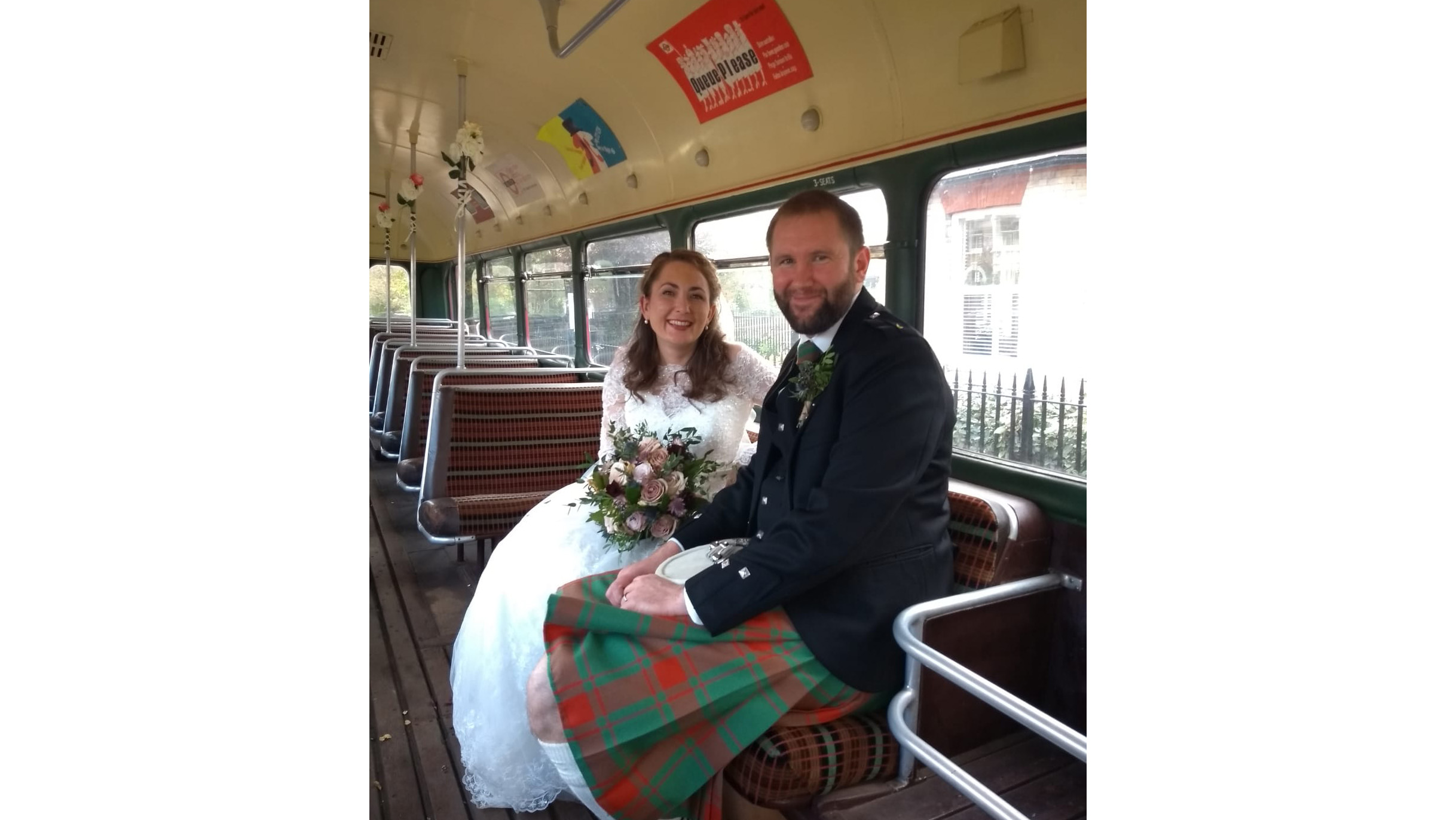 Bride and Groom seating inside a single decker bus