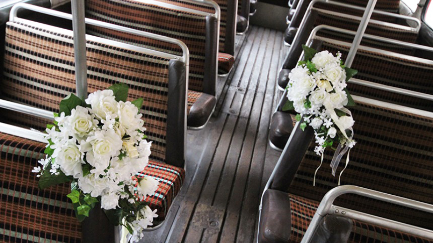 interior photo with check cloth seating and flower decorated attached to the seats