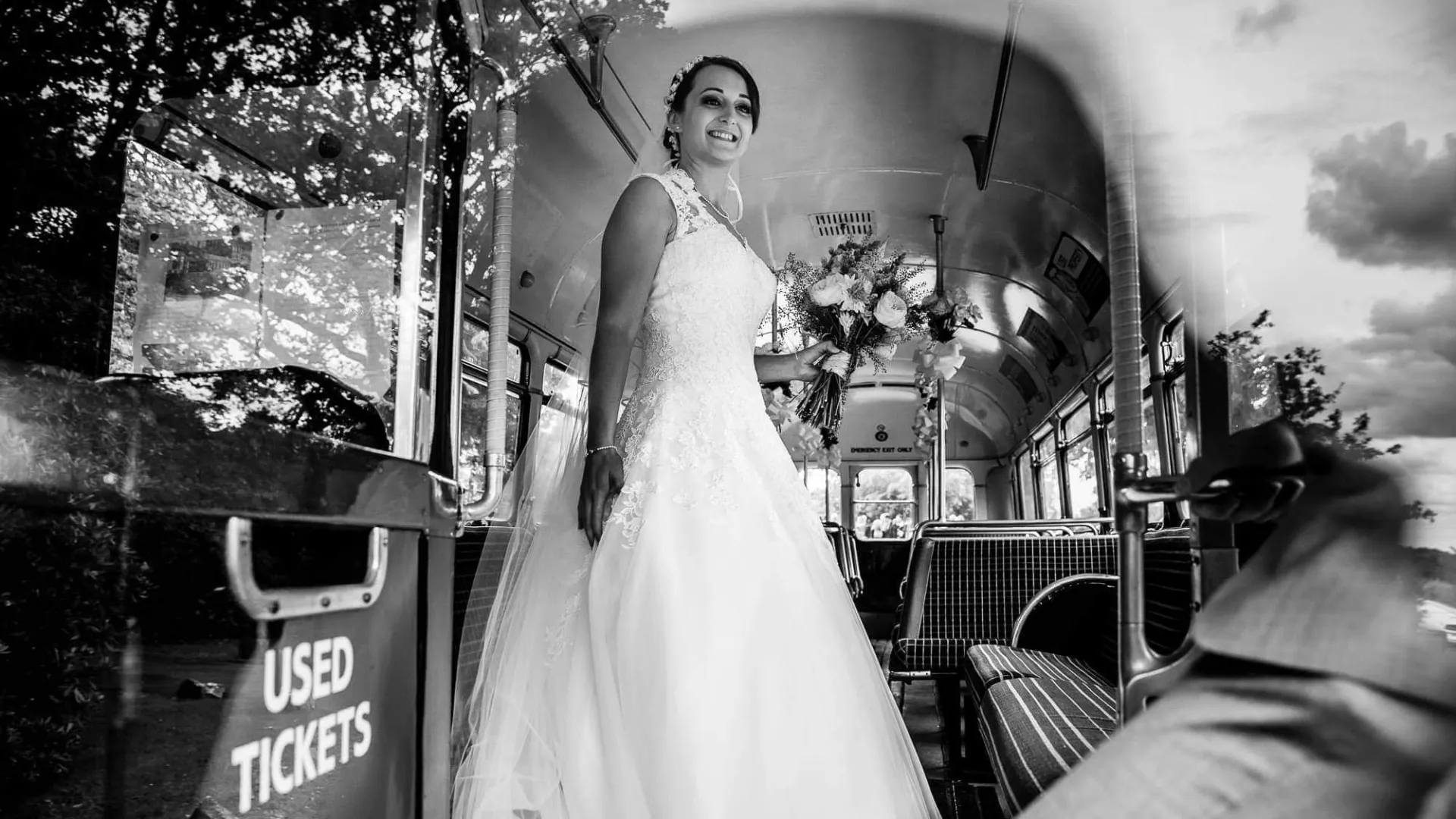 Black and White photo of Bride standing inside Vintage Red Single Decker Bus