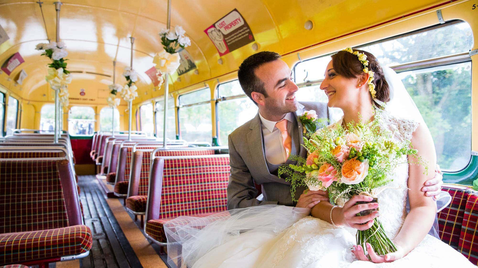 interior inside Vintage Red Single Decker Bus with Bride and Groom