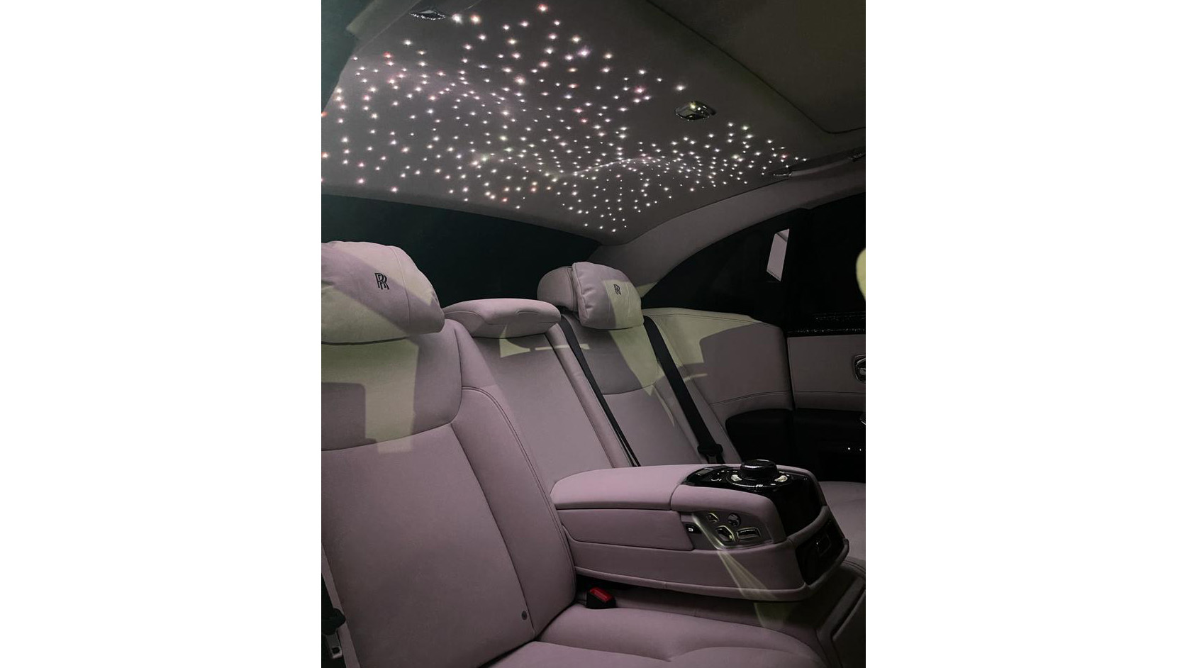 rear passenger interior at night time showing lit up sky light sunroof inside Rolls-Royce Ghost