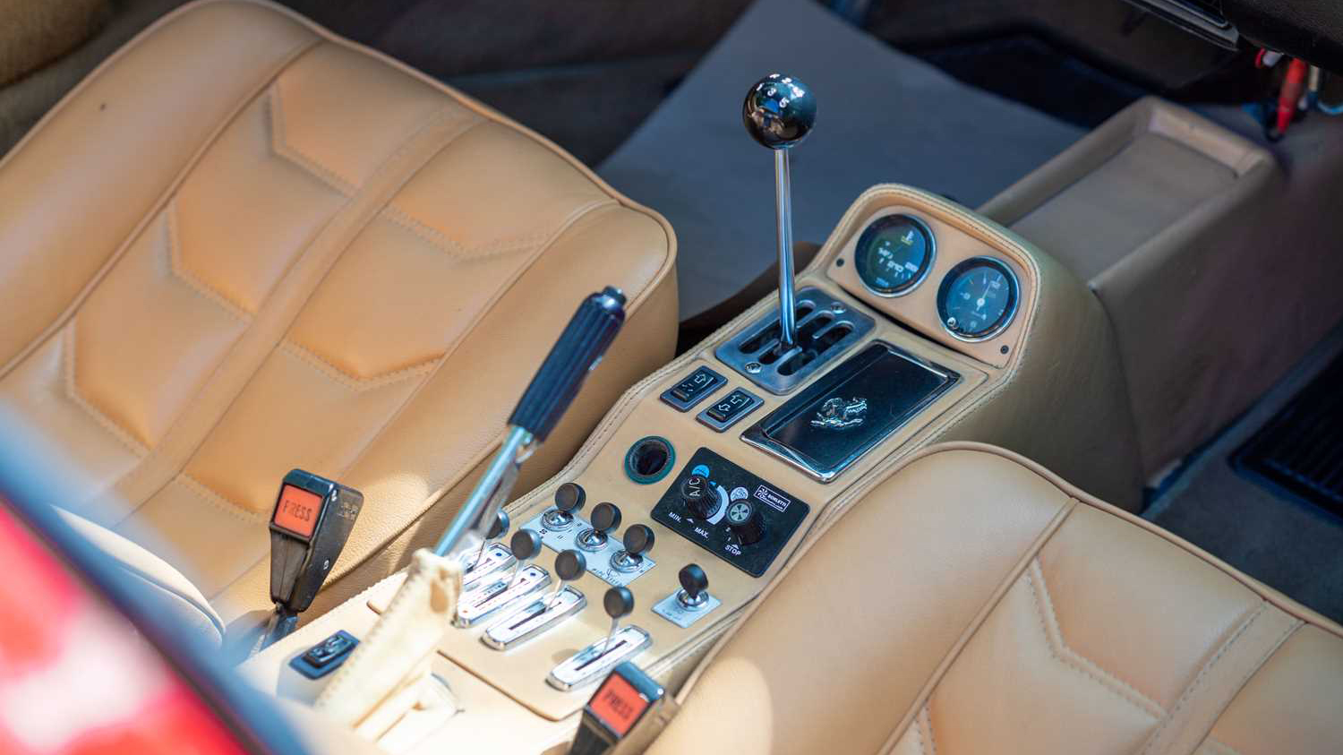 Driver's middle console and view of tan leather seats