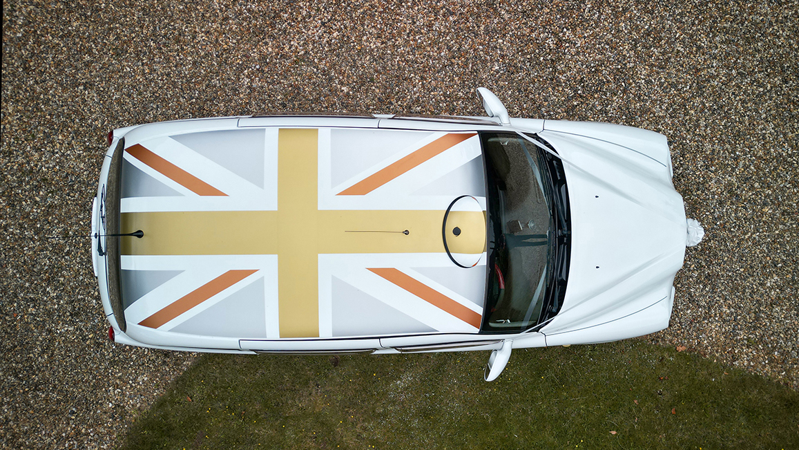 Aerial view of White taxi Cab with union jack flag roof