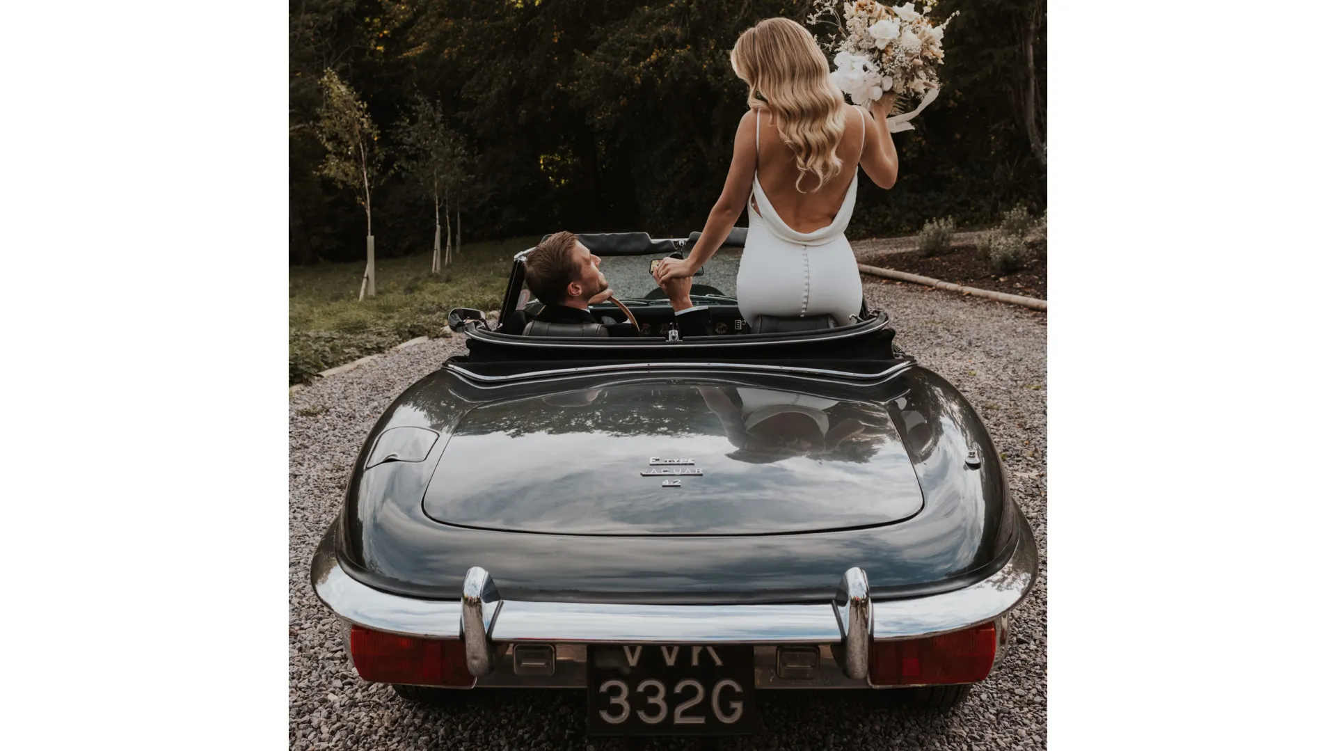 Bride and groom inside Jaguar e-type