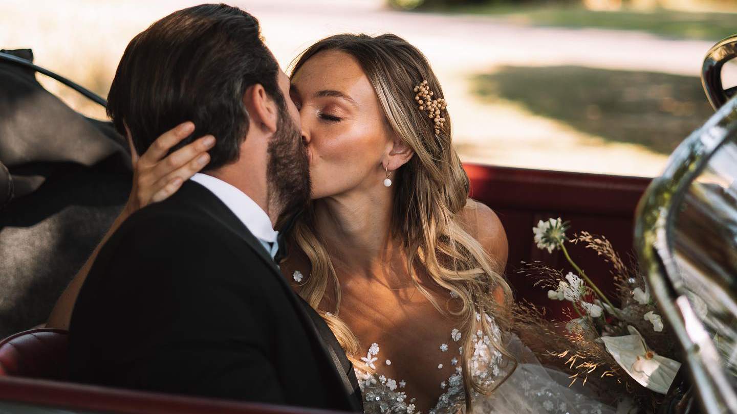 Bride and Groom kissing inside a classic Porsche