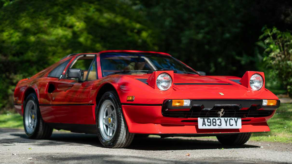 Front right side view of Red Ferrari GTSi with pop up light on