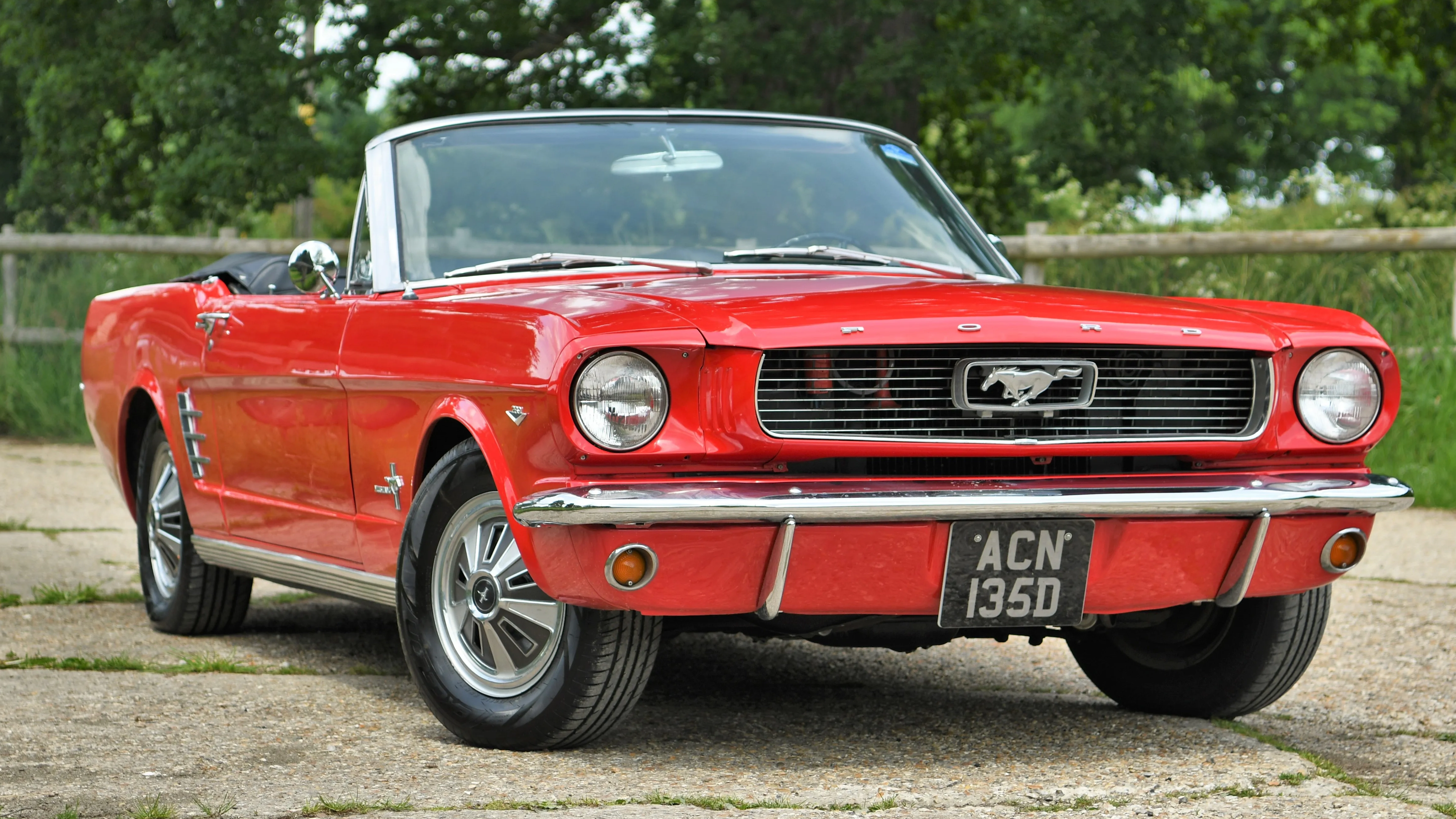 Red Ford Mutang with convertible roof down