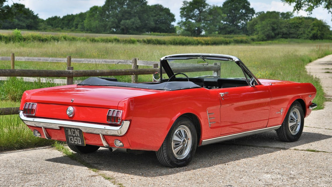 Rear view american Ford Mustang with soft top roof down