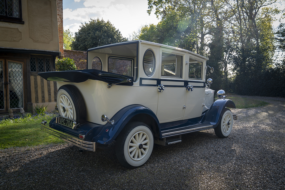 vintage wedding car with convertible roof down.