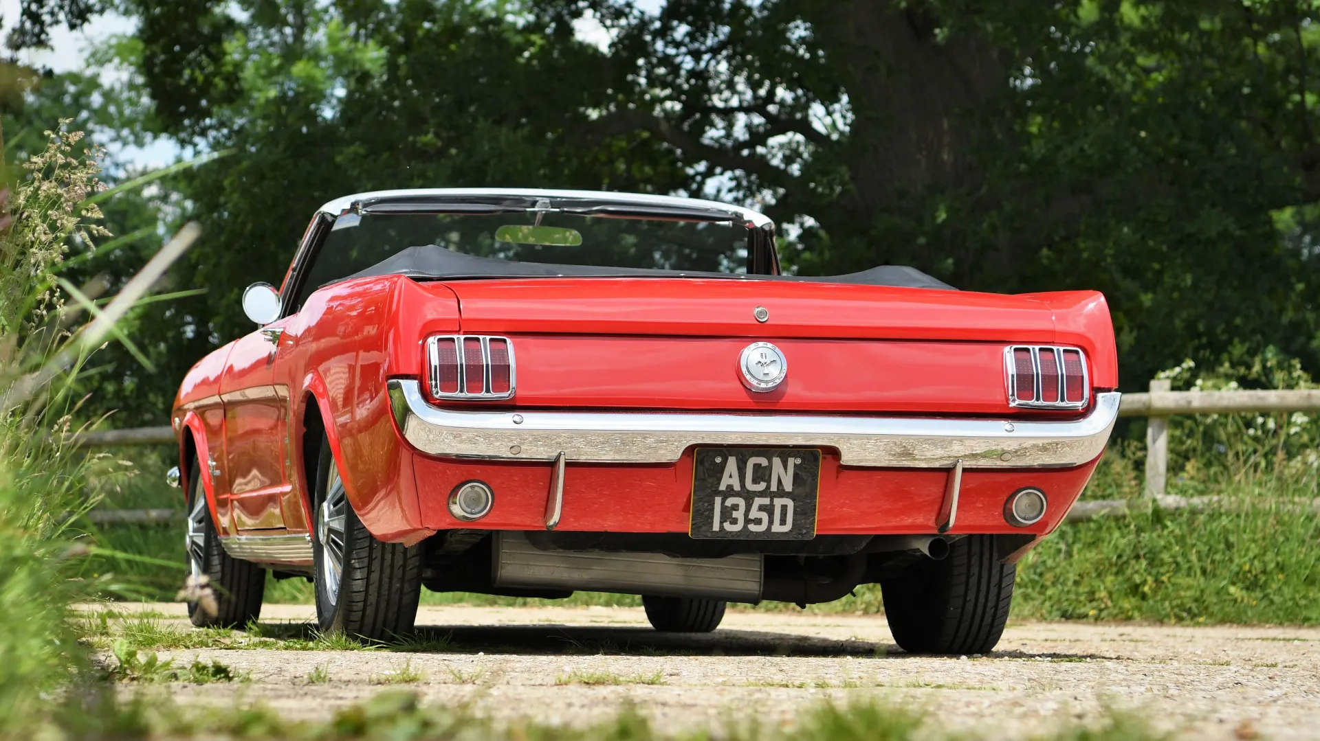 Rear view red ford mustang with chrome rear bumpers