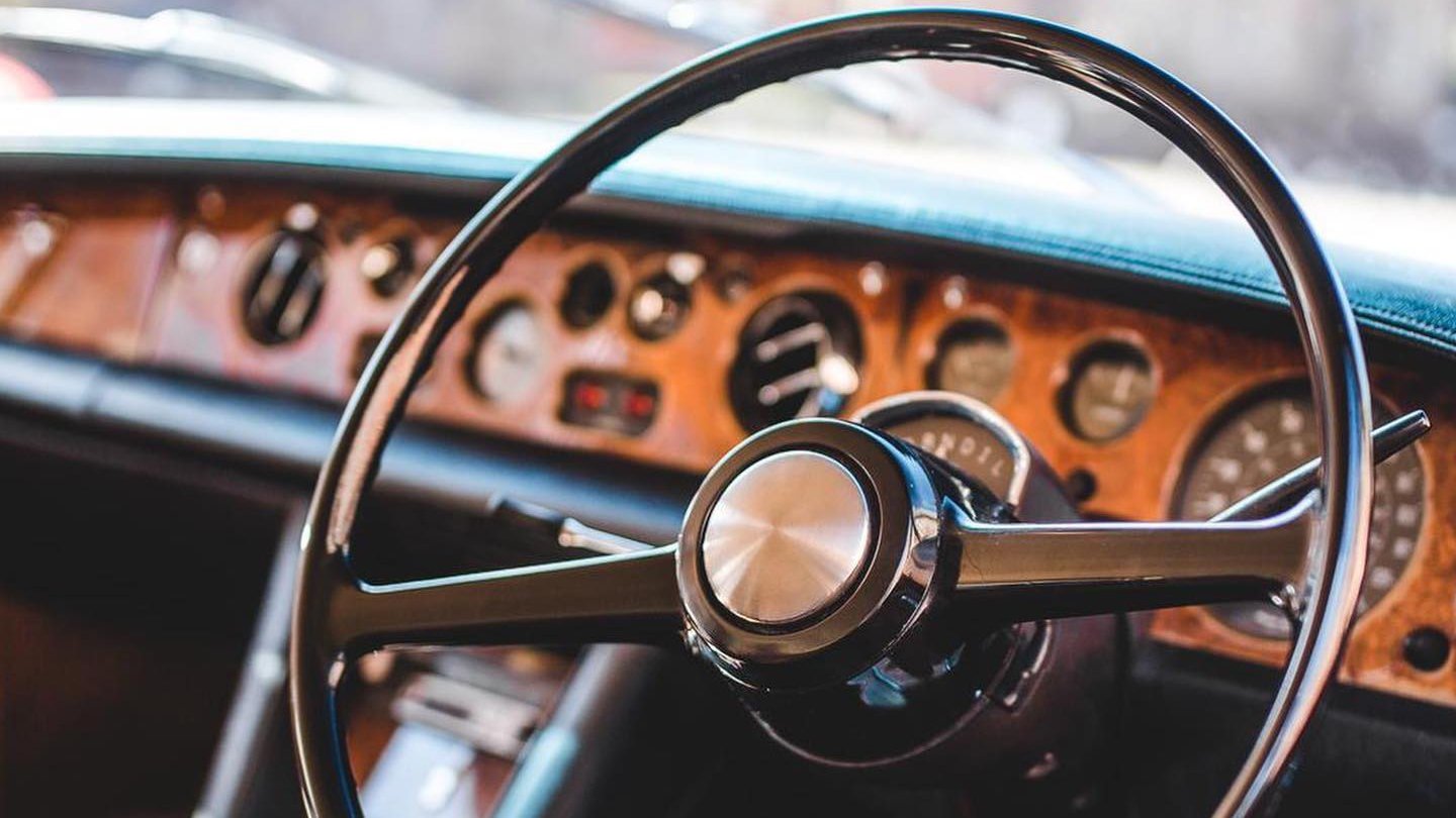 Chauffeur's front dashboard and steering wheel in Rolls-Royce silver Shadow