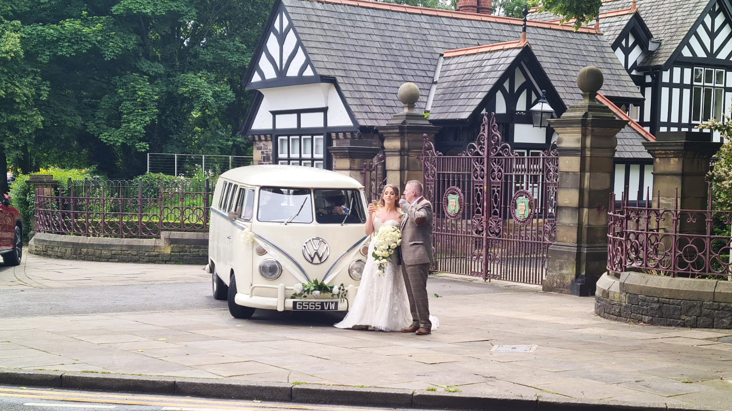 Bride and Groom standing in front of a classic VW campervan