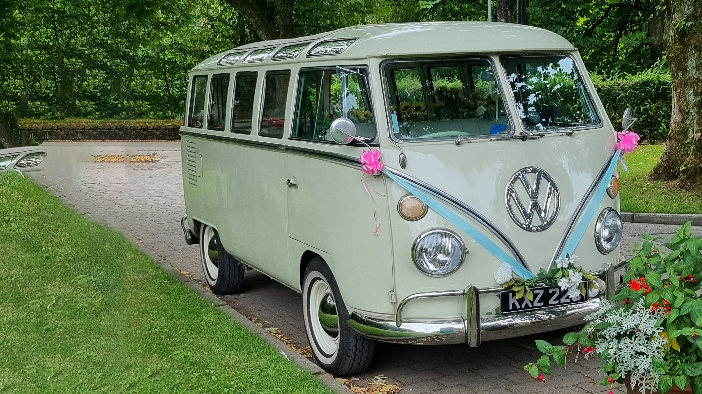 Classic Volkswagen Splitscreen Campervan decorated with turquoise blue ribbons and pink bows