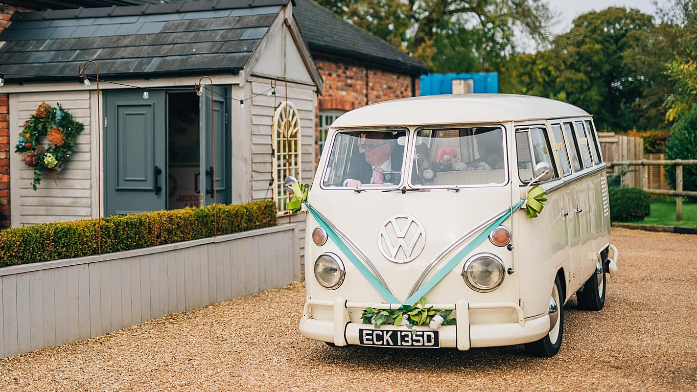 Classic vw campervan in front of Larkspur Lodge in Cheshire decorated with light blue ribbons and bows