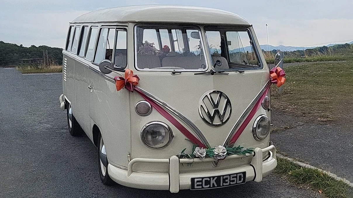 Classic VW Campervan splitscreen decorated with dark red Ribbons and bows