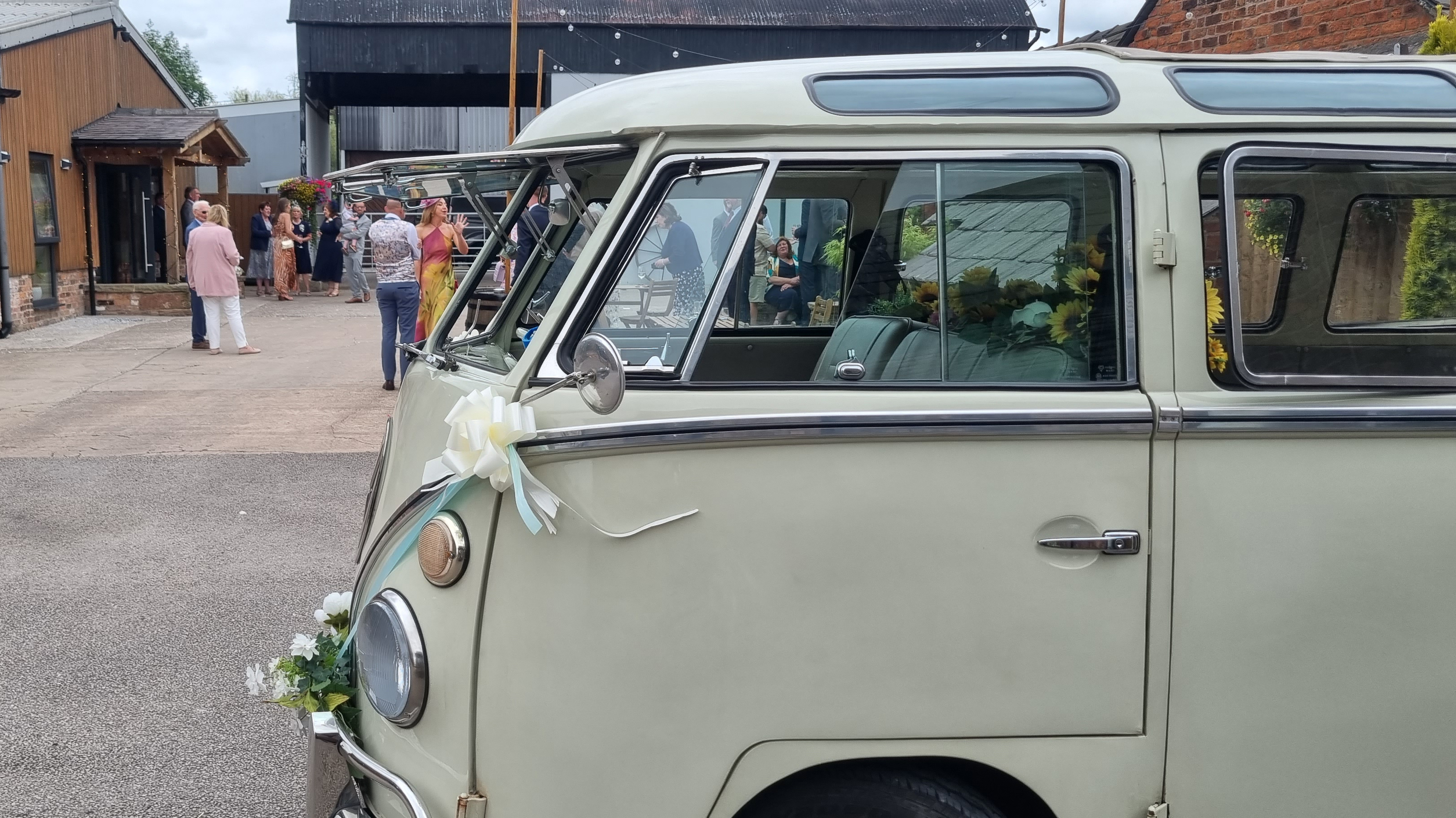 Front side view of classic VW Campervan showing the multiple windows on the side of the roof