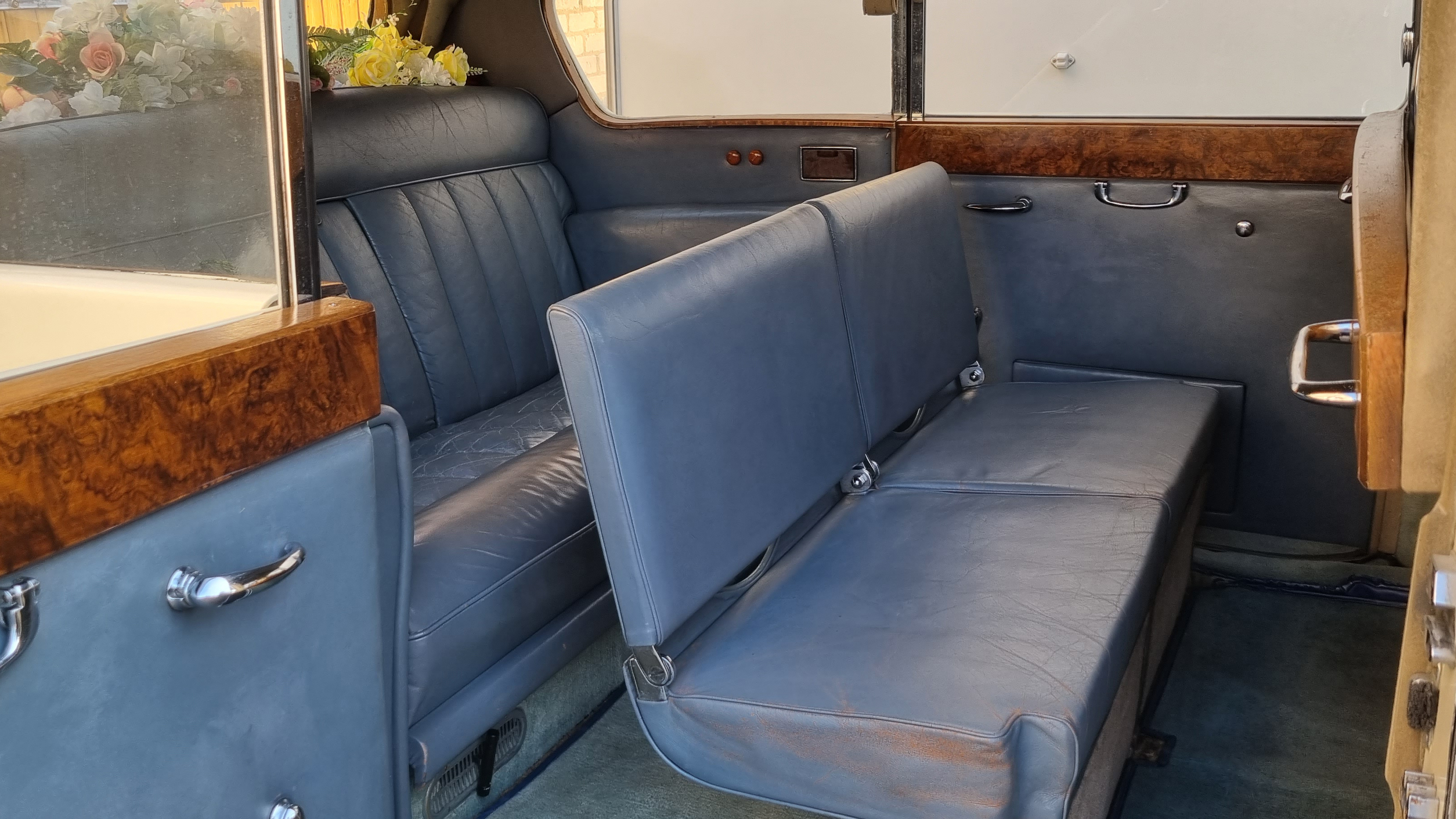 rear interior space inside Austin Princess Limousine with both casual seats up.